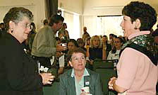 Photo of Chancellor Greenwood talking to members of the audience before her speech
