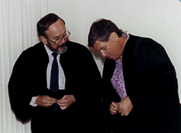 [Photo of 
astronomers Joe Miller (left) and Jerry Nelson, putting on
academic robes for the inaugural ceremony.]