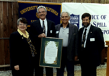 Photo of group holding commemorative plaque