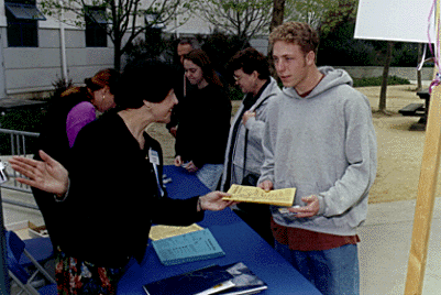 [Photo of student at registration table]