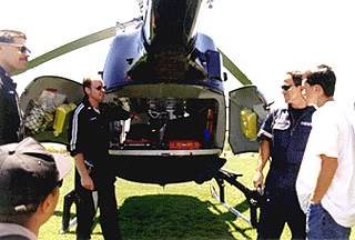 [Photo of CalSTAR's Eric Lewis showing the back of the helicopter where patients
are loaded]