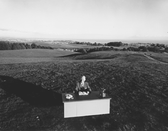 [Photo of Dean McHenry at desk in field]