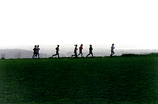 Photo of women jogging around field