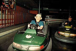 [Photo of Chancellor Greenwood on bumper cars]