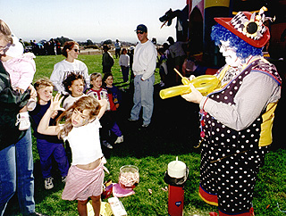 [Photo of child with clown]