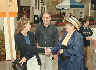 [Photo of Chancellor Greenwood and parents at move-in]