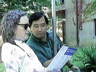 [Photo of people with brochure]