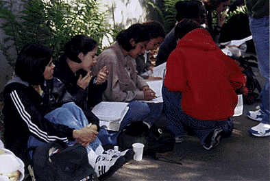 [Picture of students studying and one fixing her makeup during Hahn Student Services Building protest]