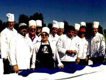[Photo of administrators in chef hats and coats