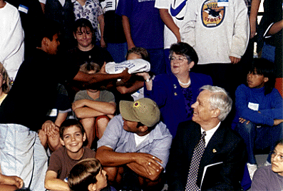 [Photo of Chancellor Greenwood accepting shirt from Branciforte student]