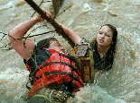 [Photo of fireman saving teenager from flood water]