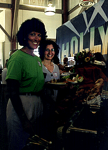[Photo of Pam Lawson and Anne Callahan at food table]