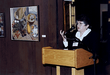 [Photo of Chancellor Greenwood with one of Farr's paintings in background]