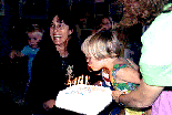 [Photo of Lise Bixler and child with anniversary cake]