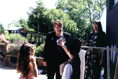 [Photo of Chancellor Greenwood outside with two kids]
