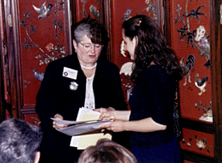 [Photo Chancellor Greenwood giving an award to a student]