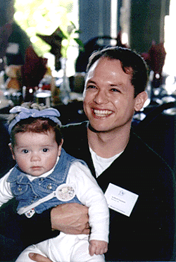 [Photo of Gilbert Guzman and child]