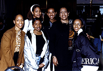 [Photo of Myrlie Evers-Williams and a group of pre-college students]