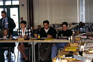 [Photo of students and others tasting food]