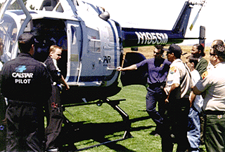 [Photo of nurse Eric Lewis showing the interior of the B-105 CalSTAR helicopter]