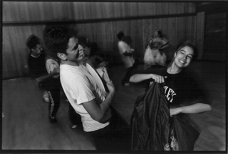 [Photo of two dancers smiling at each other]