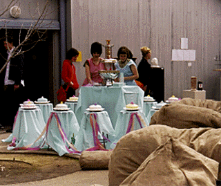 [Photo of UCSC students with cake art installation]