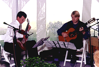 [Photo of Michael Tanner and William Coulter playing guitars]