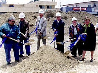 [Photo of city and university officials and the developer breaking ground on the site]