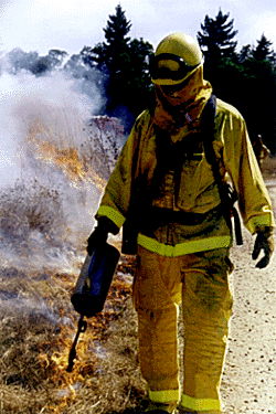 [Photo of Troy Souza lighting fire]