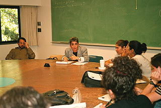 [Photo of group around table]