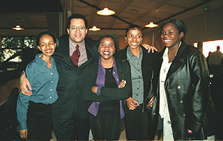 [Photo of Dyson with women at Outreach event]