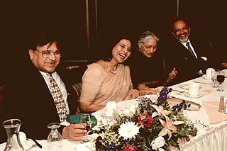 [Photo of Bhandaris and others at banquet]