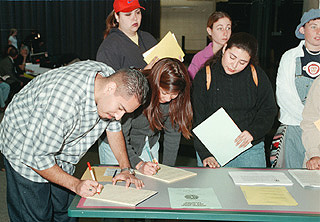 [Photo of students signing in]